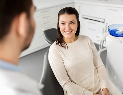 Patient smiling while talking to a cosmetic dentist