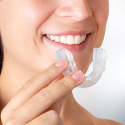 Woman using occlusal splint for TMD pain relief