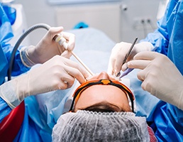 dentist and assistant performing dental surgery