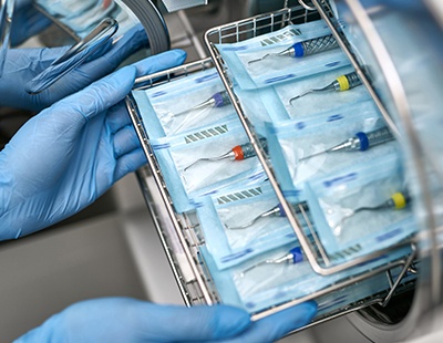 Dental team member sterilizing instruments