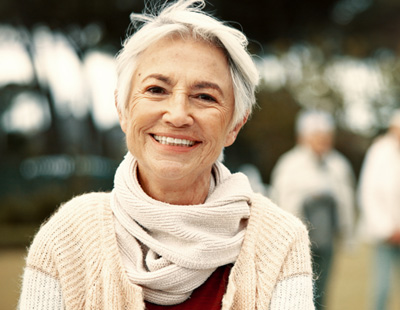 Senior woman wearing scarf and smiling