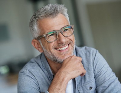 older man smiling with dental bridges in Aspen Hill