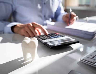 Man calculating the cost of cosmetic dentistry in Aspen Hill