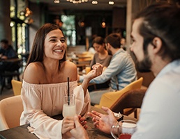 Woman smiling while on date at restaurant