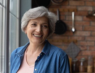 Woman smiling by a window