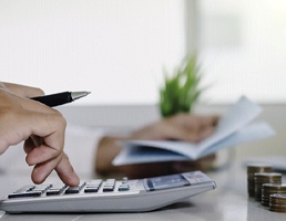 Man calculating cost of dentures in Aspen Hill