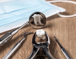 dental tools and a tooth on a table 