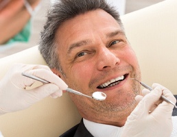 Man smiling at dentist with dental implants in Silver Spring