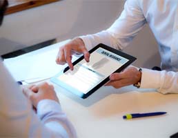 Dentist pointing to dental insurance paperwork