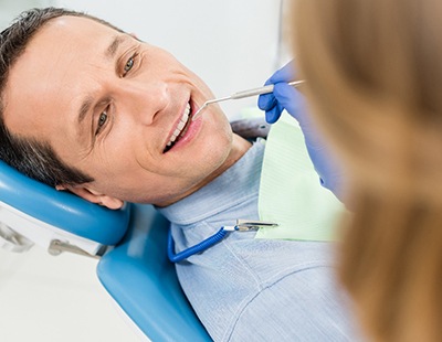 Man receiving exam from an implant dentist in Aspen Hill