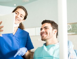 Dentist showing patient image on tablet