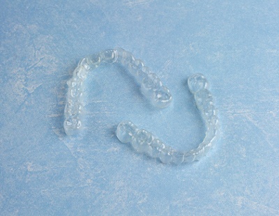 Close up of Invisalign in Aspen Hill with blue background