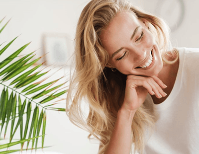 a woman grinning after undergoing a smile makeover