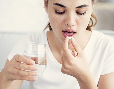 Patient taking oral antibiotic pill for gum disease