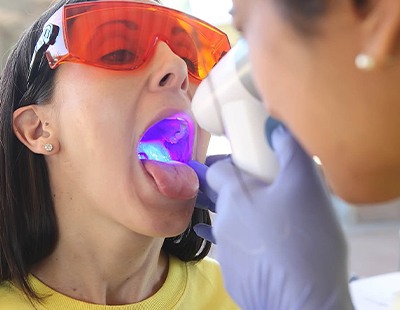 Dentist performing oral cancer screening