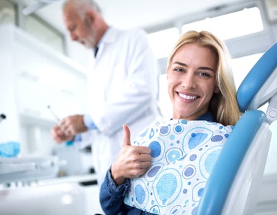 woman in the dental chair giving a thumbs-up