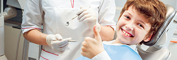 Smiling boy in dental chair for children's dentistry