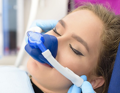 Woman with nitrous oxide nose mask