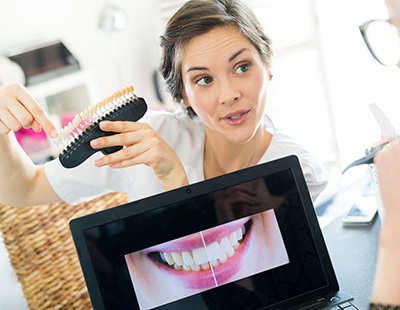 a cosmetic dentist explaining the porcelain veneers process to a patient