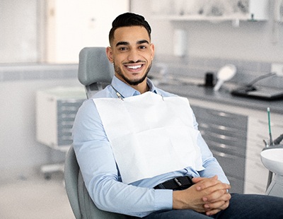 Smiling man sitting in dental office