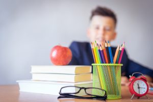 Young male student sitting at desk