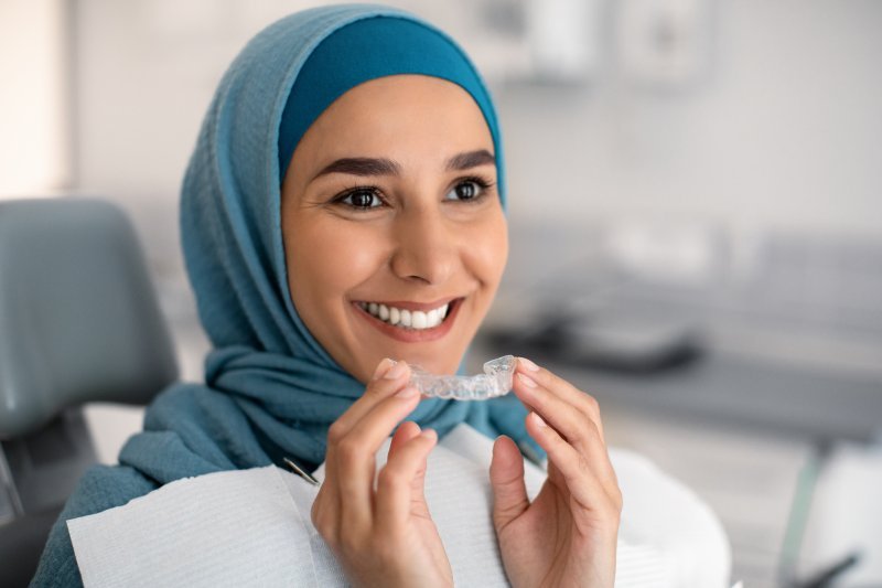 Patient putting in their Invisalign aligner