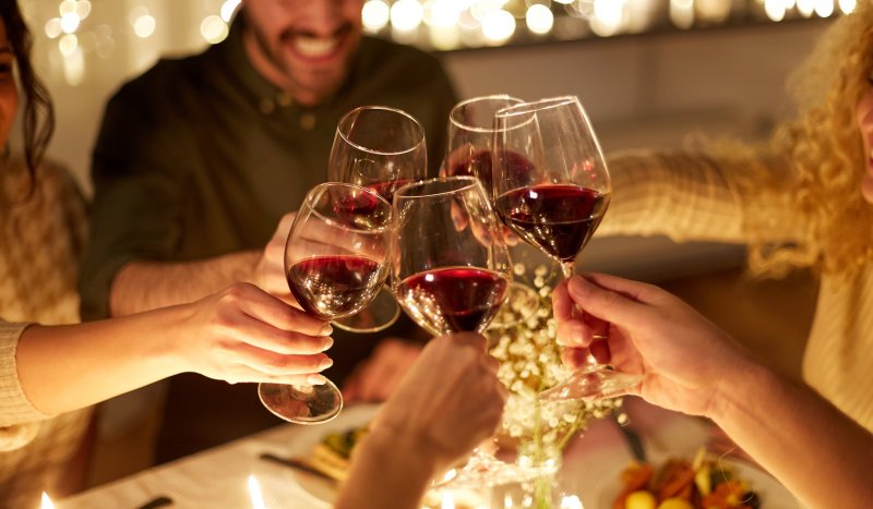 Friends toasting glasses of red wine during the holidays