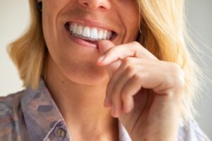Middle-aged woman fitting on clear aligner.